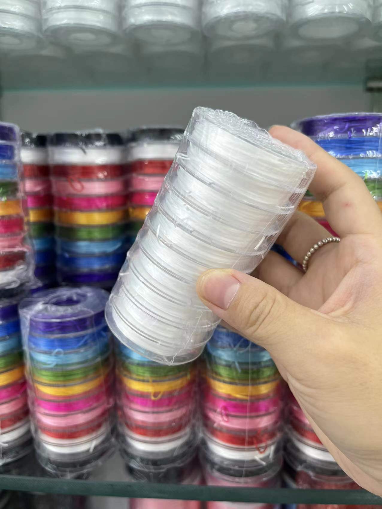 White and colorful stretch strings smaller rolls, sold by 10 small rolls